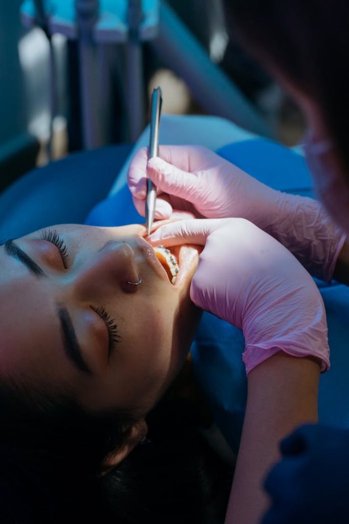 Close-up of a dentist examining a patient's teeth during a dental check-up.